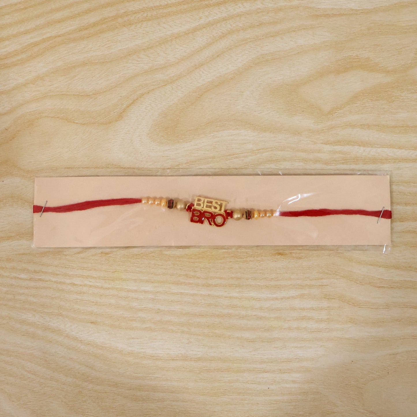 Full-length view of pearl Beads Rakhi with red thread