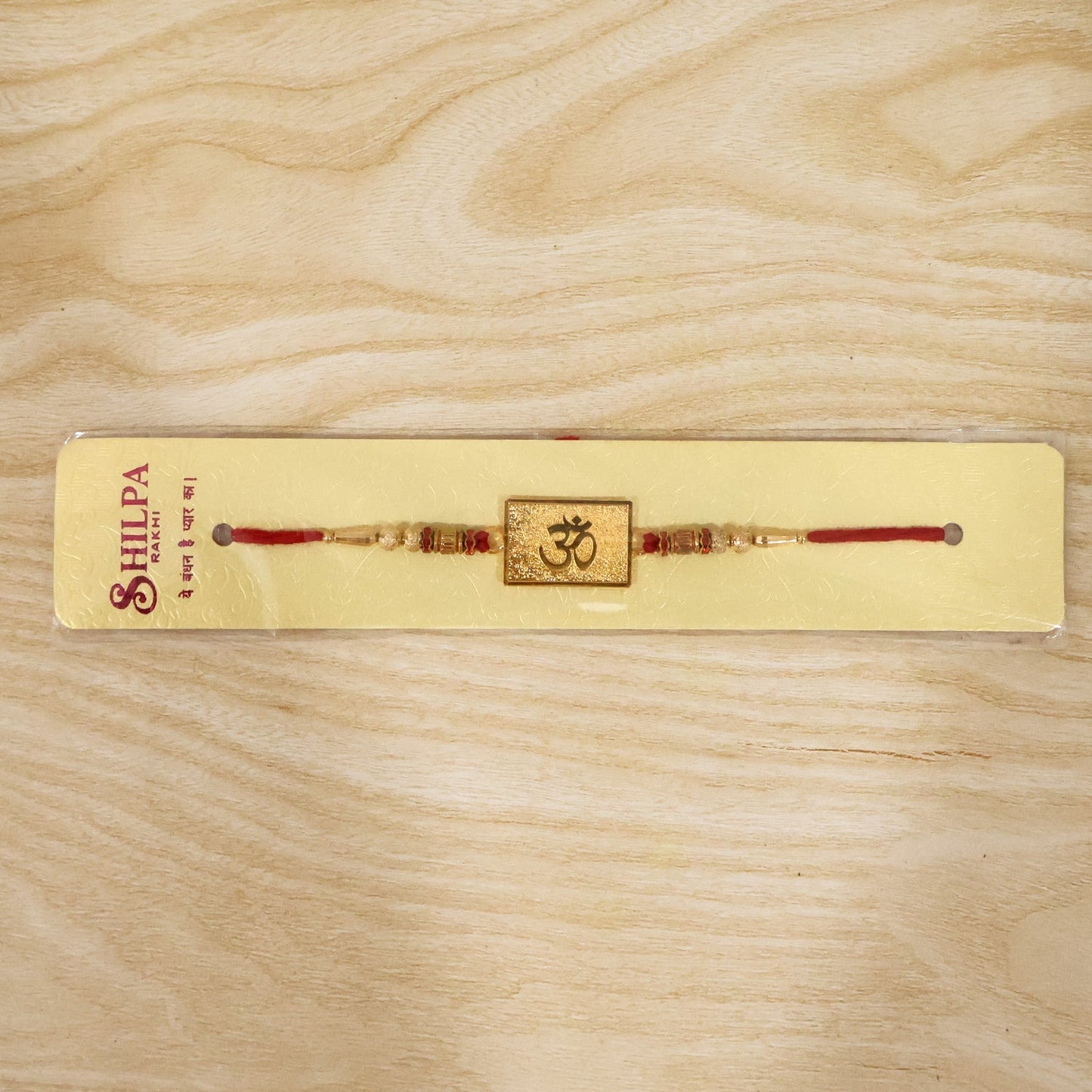 Om designer rakhi tied with red thread ready to wear