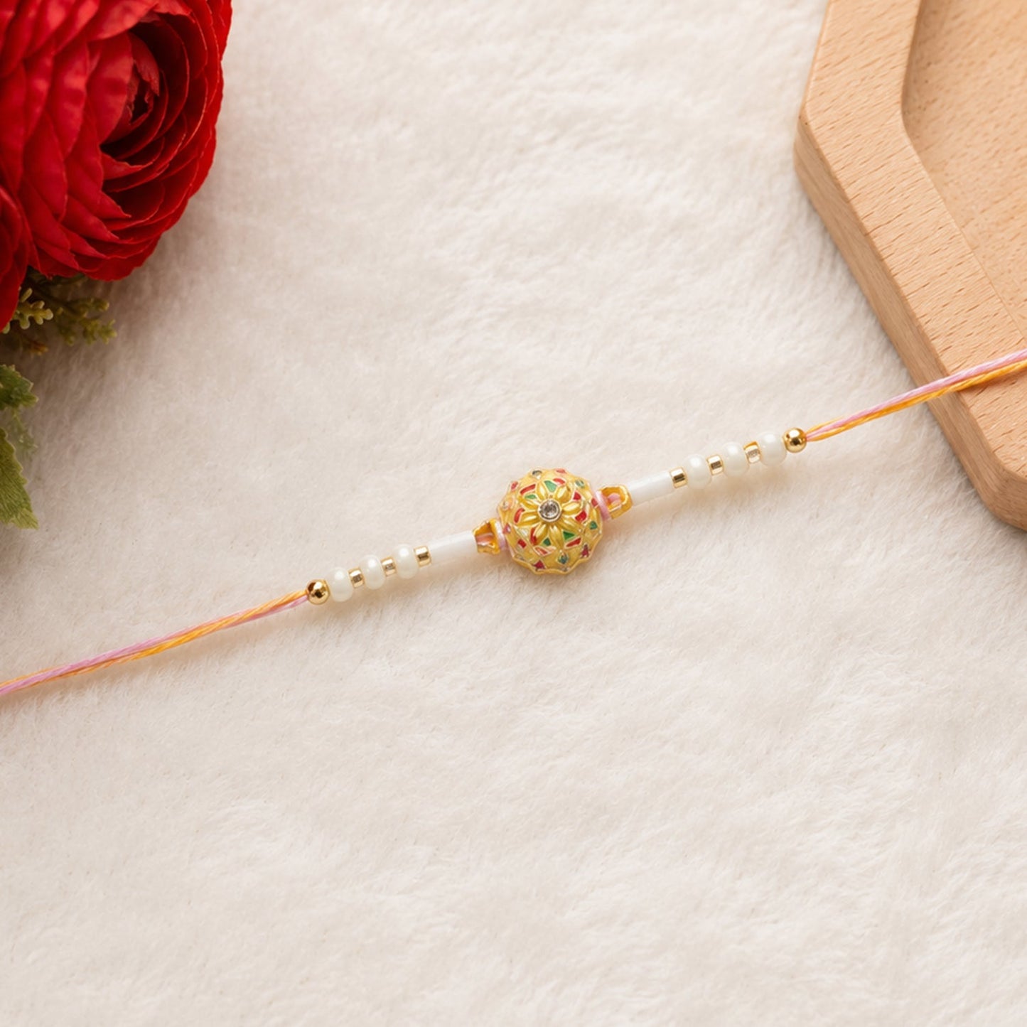 Rakhi tied with thread, ready for Raksha Bandhan.