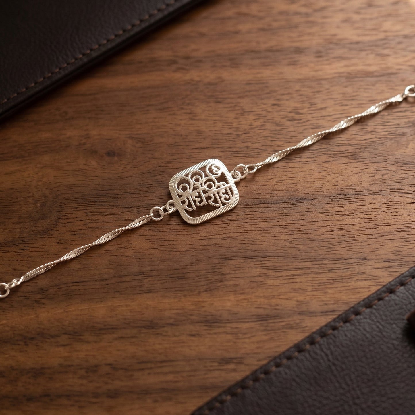 Stylish Silver Radhe Radhe Rakhi tied on a brother’s wrist for Rakshabandhan.