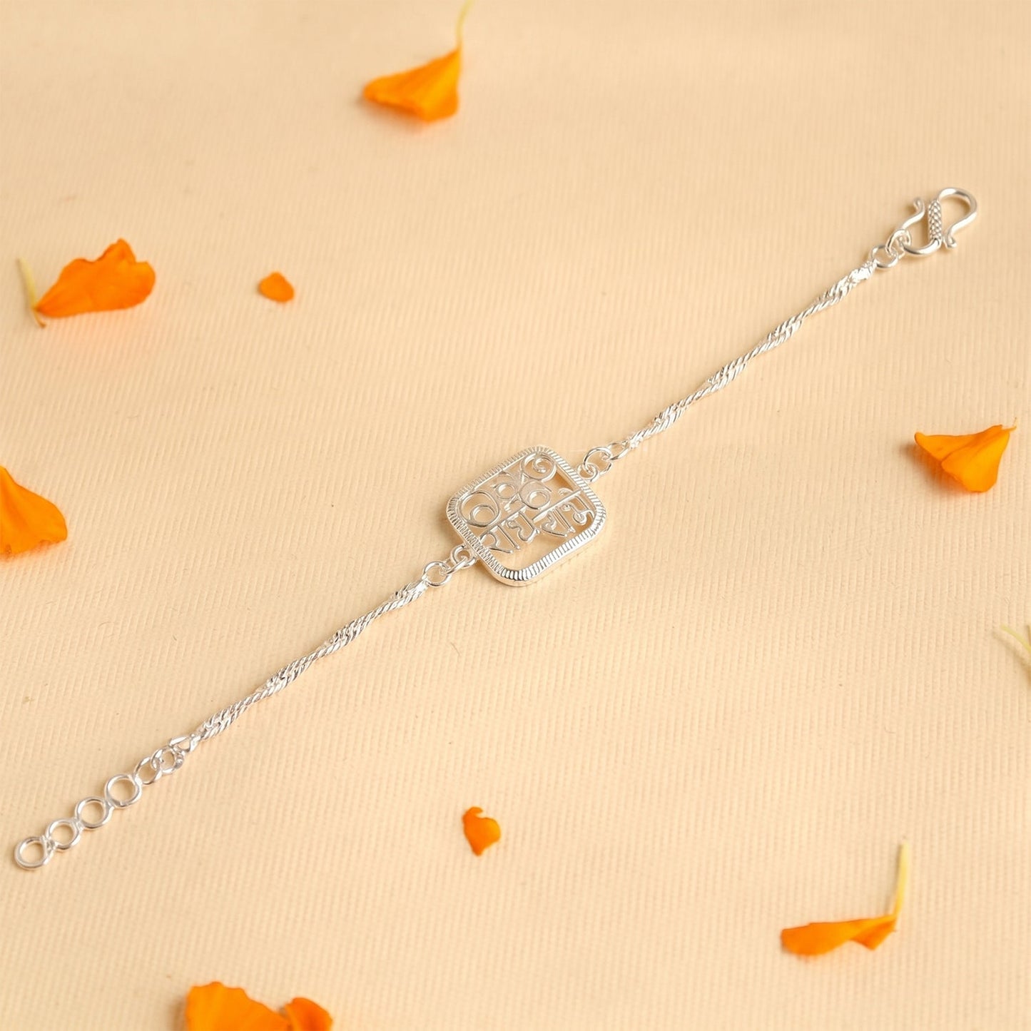 Side angle of Silver Radhe Radhe Rakhi showcasing its design.