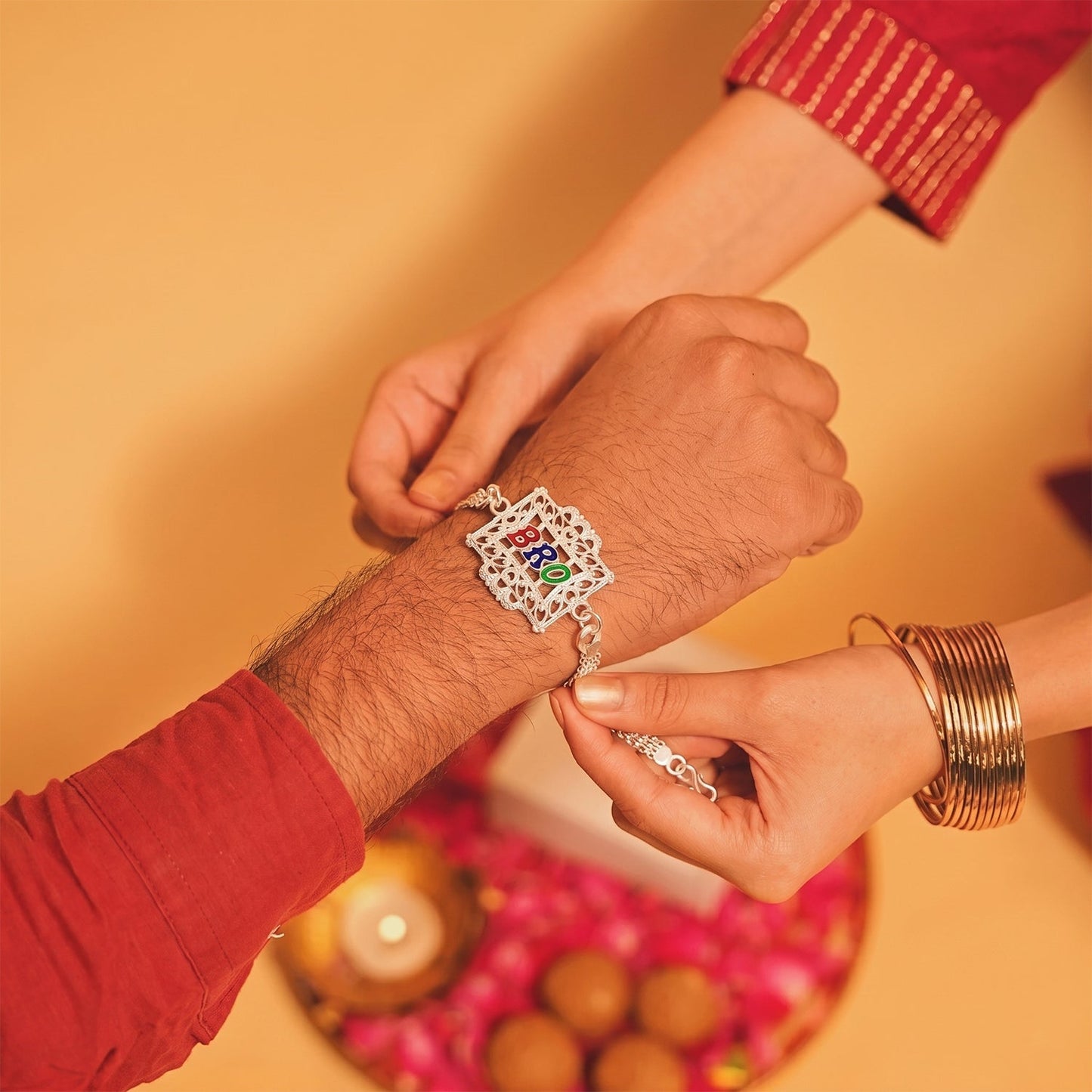 Side angle perspective of the designer Silver Rakhi, highlighting intricate details.