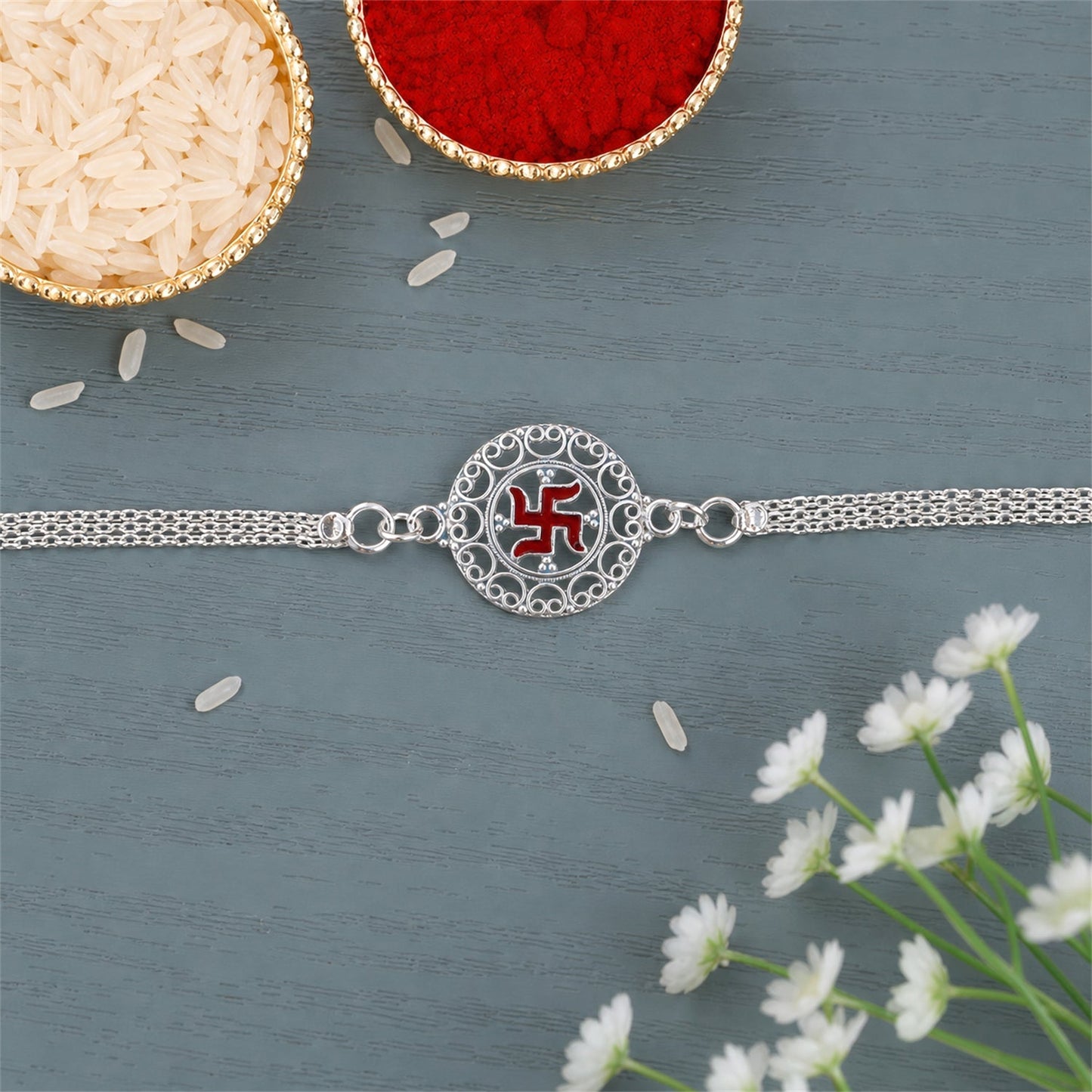 Silver Swastik Rakhi showing chain and motif design