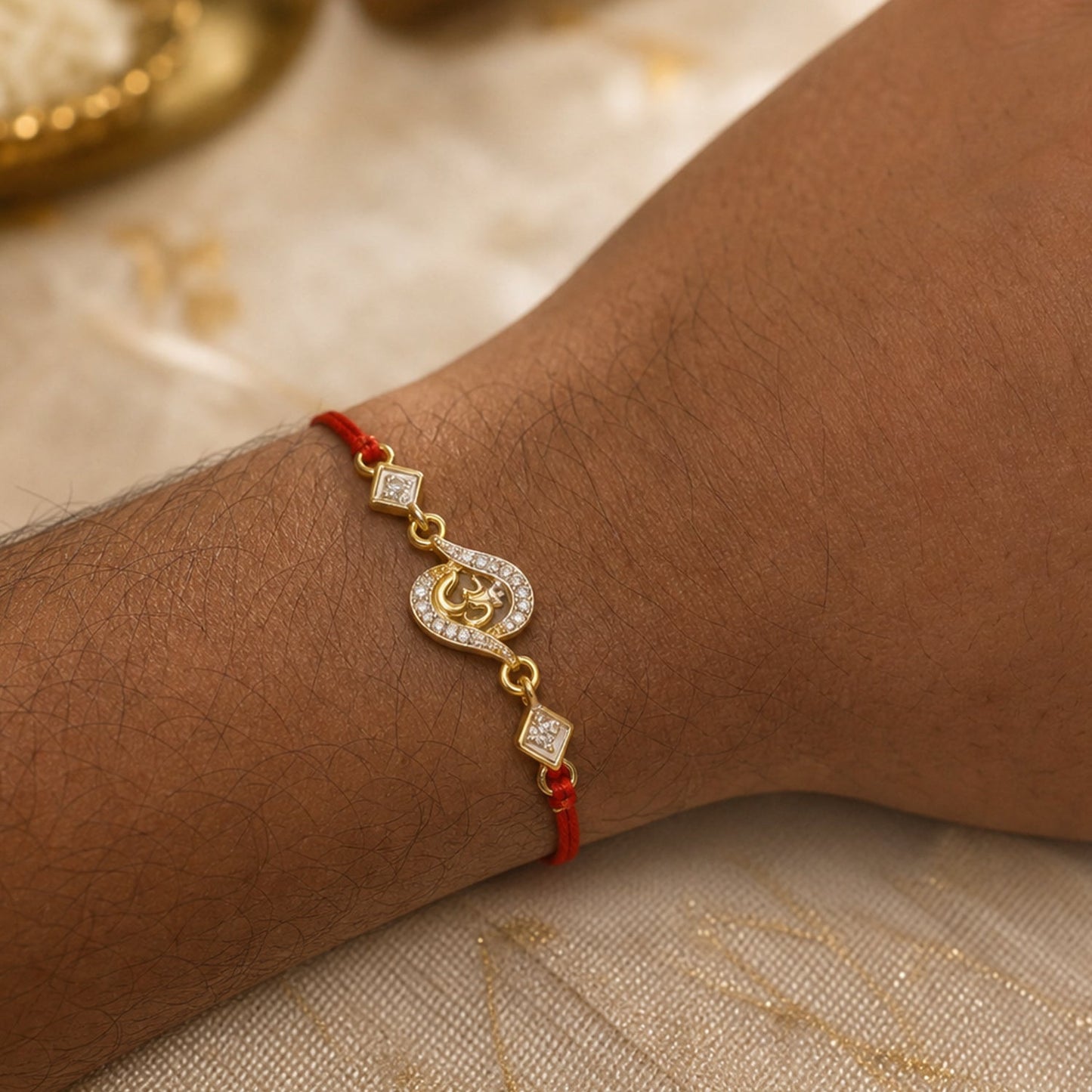 Close-up of red thread tied on Om Rakhi