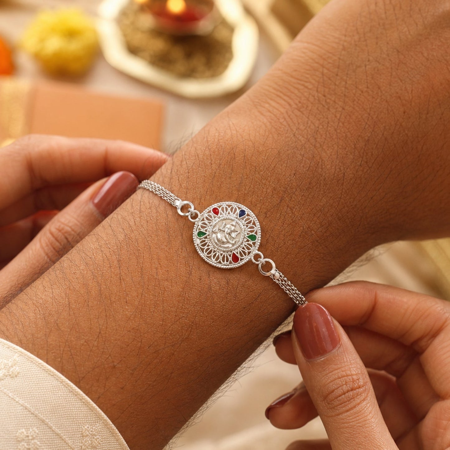 Close-up of Silver Ganesh Rakhi with detailed designer motif