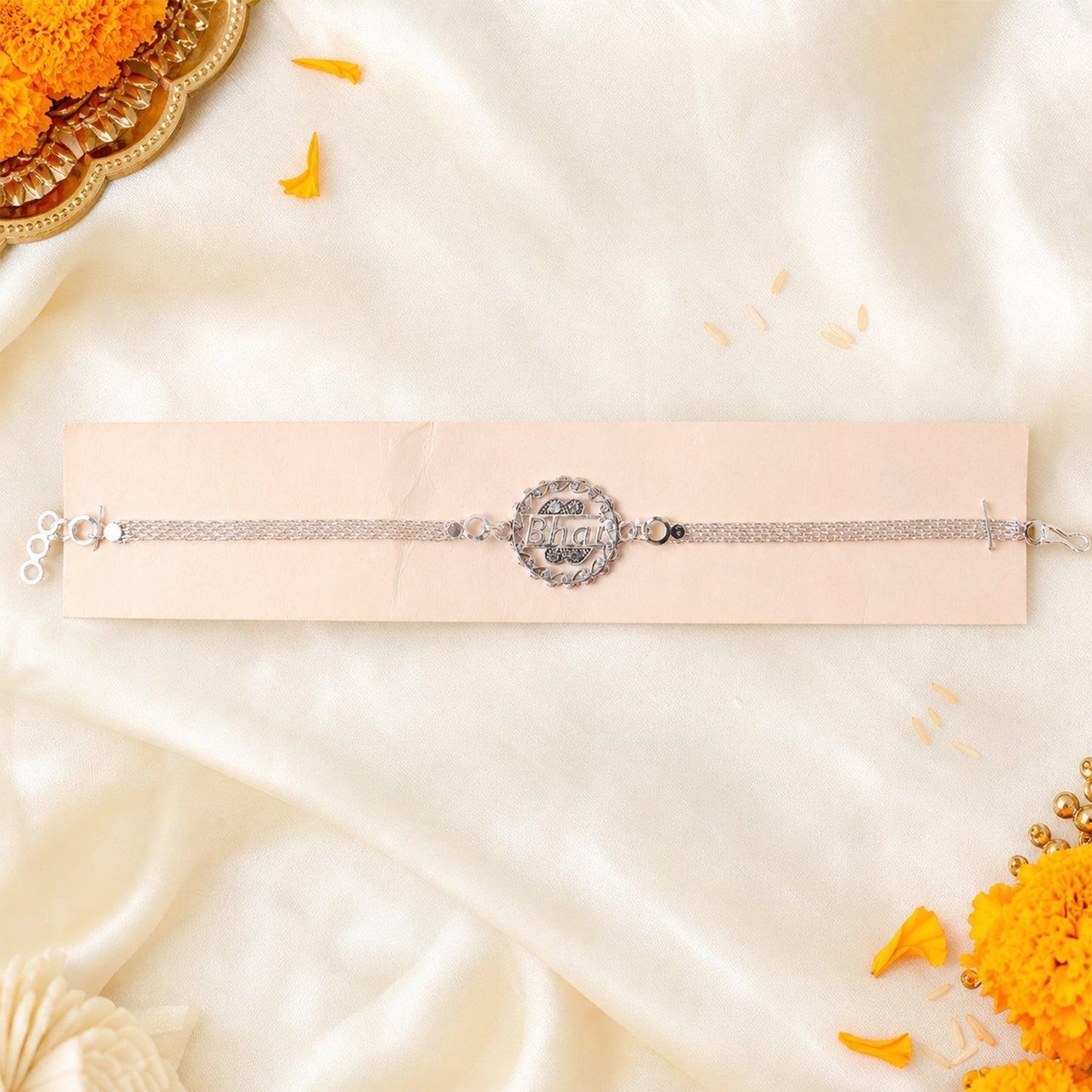 The sleek Silver Bhai Chain Rakhi laid out, showcasing its full design and chain.
