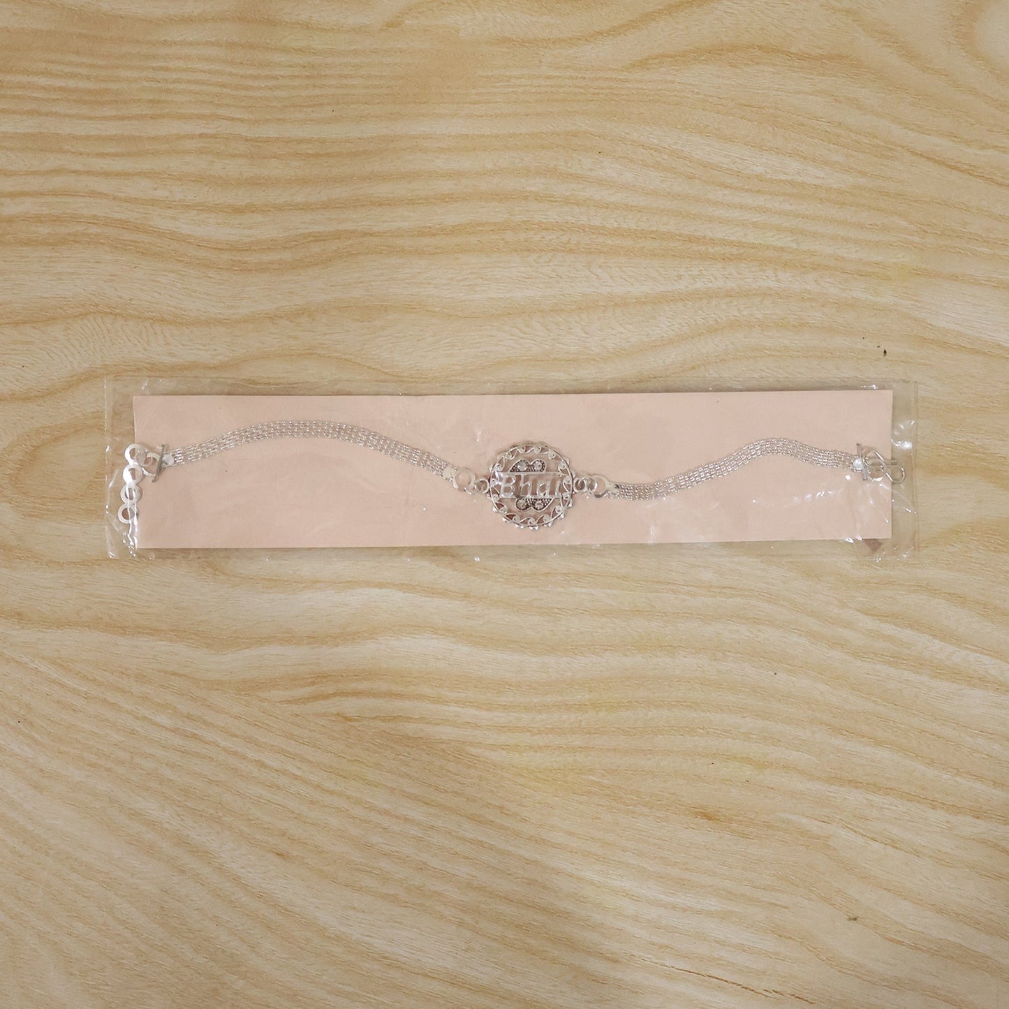 Silver Bhai Chain Rakhi displayed on a festive background, ready for celebration.