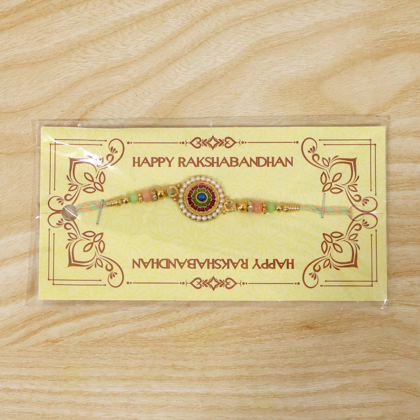 Pearl floral rakhi tied with thread, ready for gifting