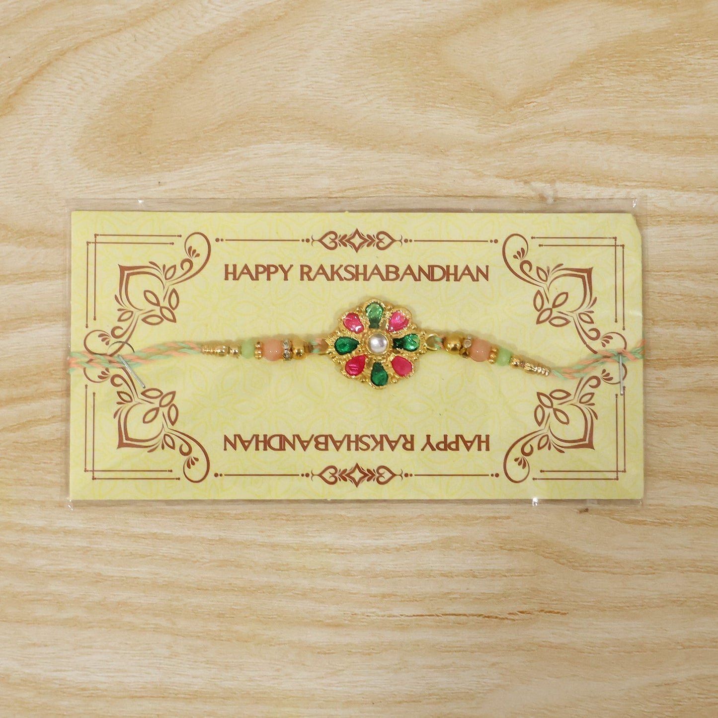 Bright and festive rakhi featuring colorful flower charm and beads
