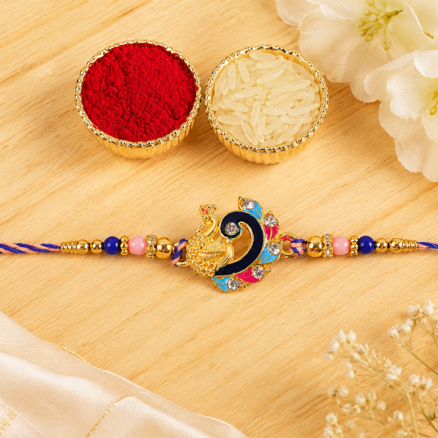 Festive blue enamel peacock charm rakhi for brother