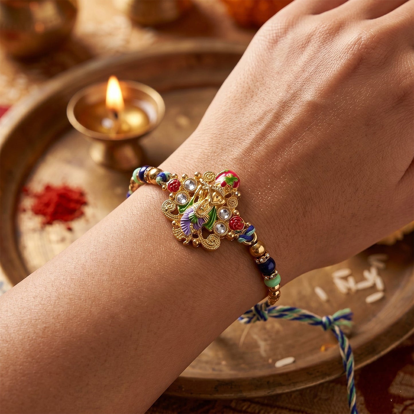 Close-up of divine idol charm on colourful rakhi with beads
