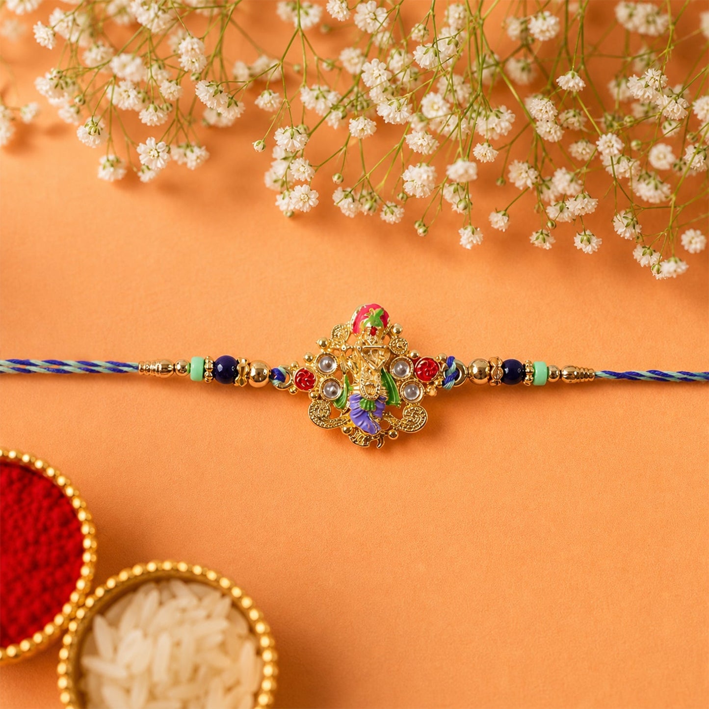 Side view of colourful designer rakhi with divine idol charm