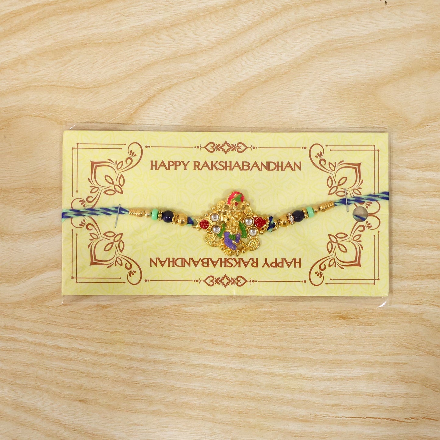 Detailed view of beads and divine idol on rakhi for brother