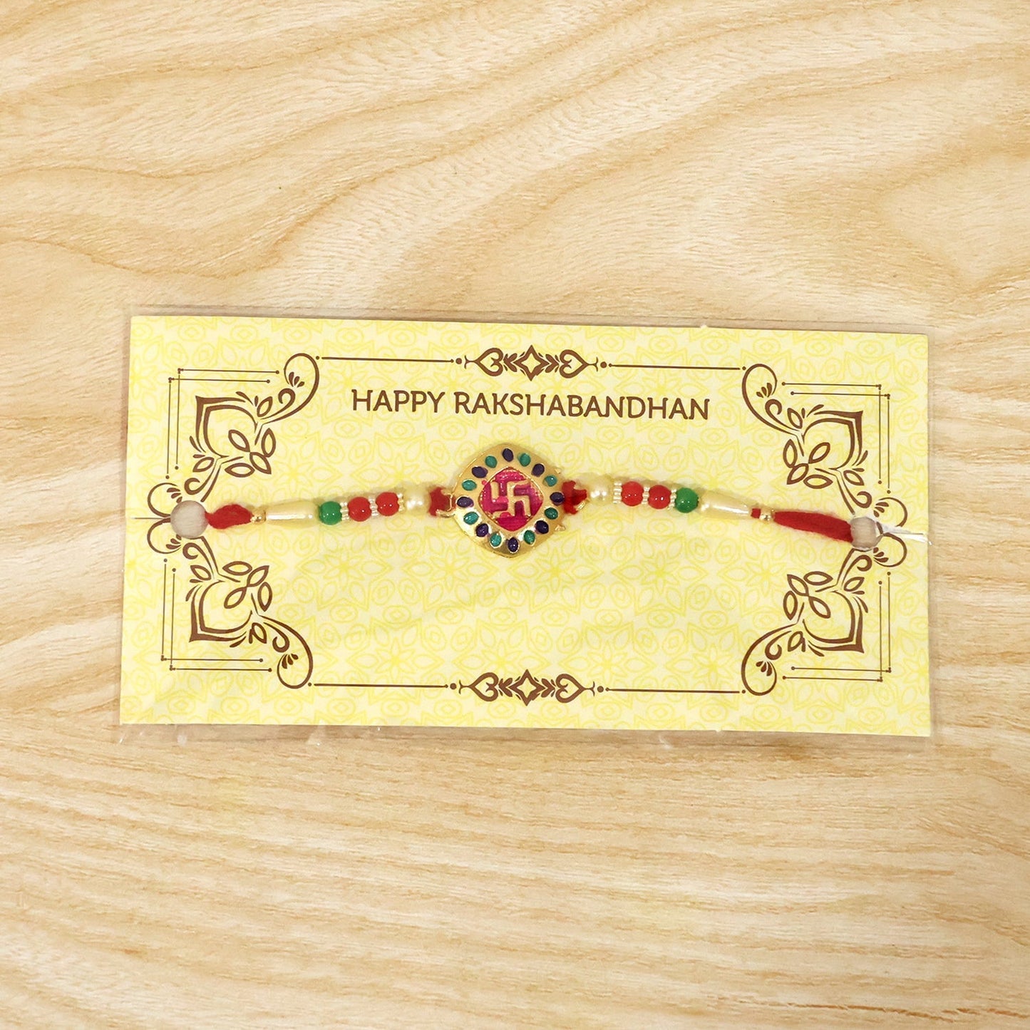 Traditional Raksha Bandhan rakhi with swastik charm and beads