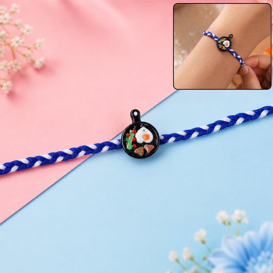 Mini frying pan-shaped rakhi front view, perfect for brothers