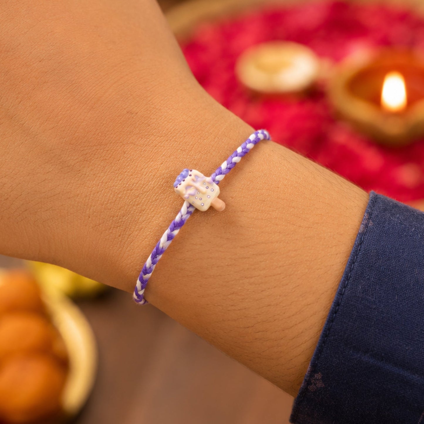 Detailed view of the festive dori thread and designer elements of the rakhi.