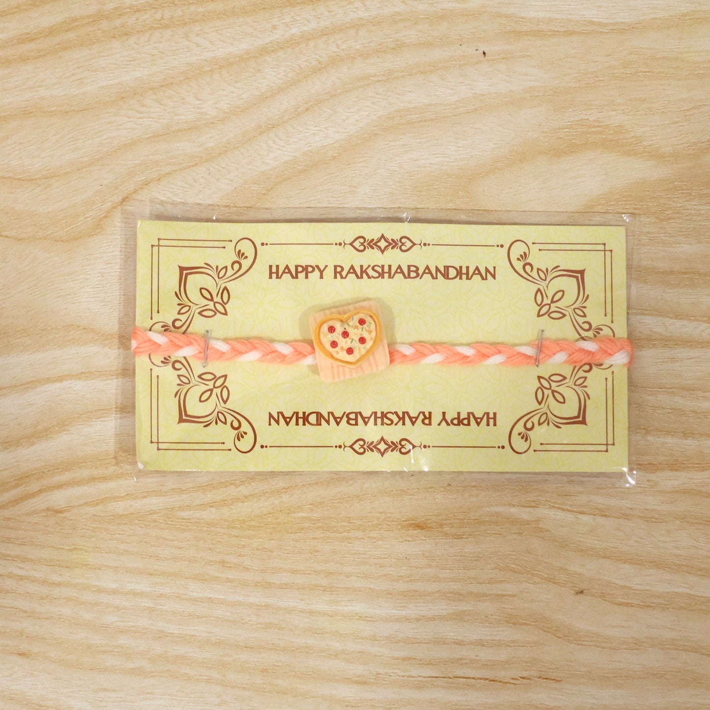 Detailed view of the design featuring the heart pizza charm and festive thread