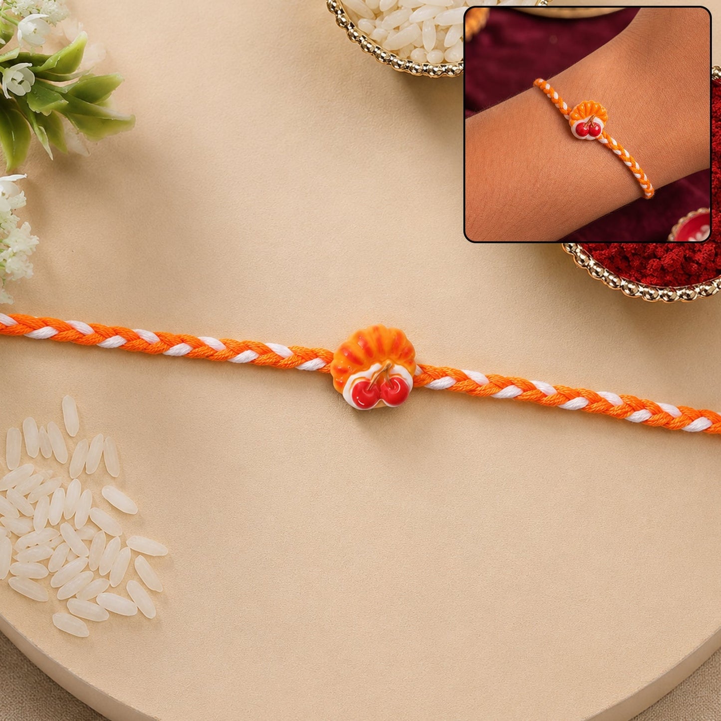 Elegant Cherry Pastry Charm Rakhi for Brother, showcasing its unique design.