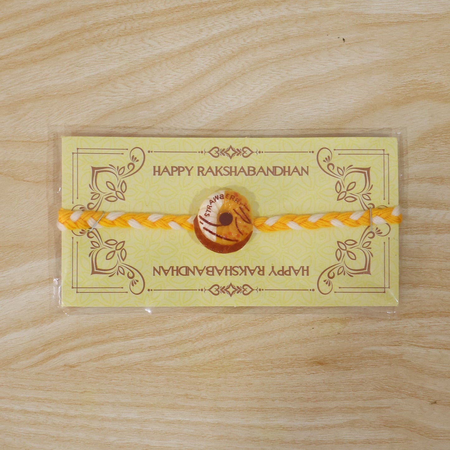 Side angle of donut charm dori rakhi showcasing design