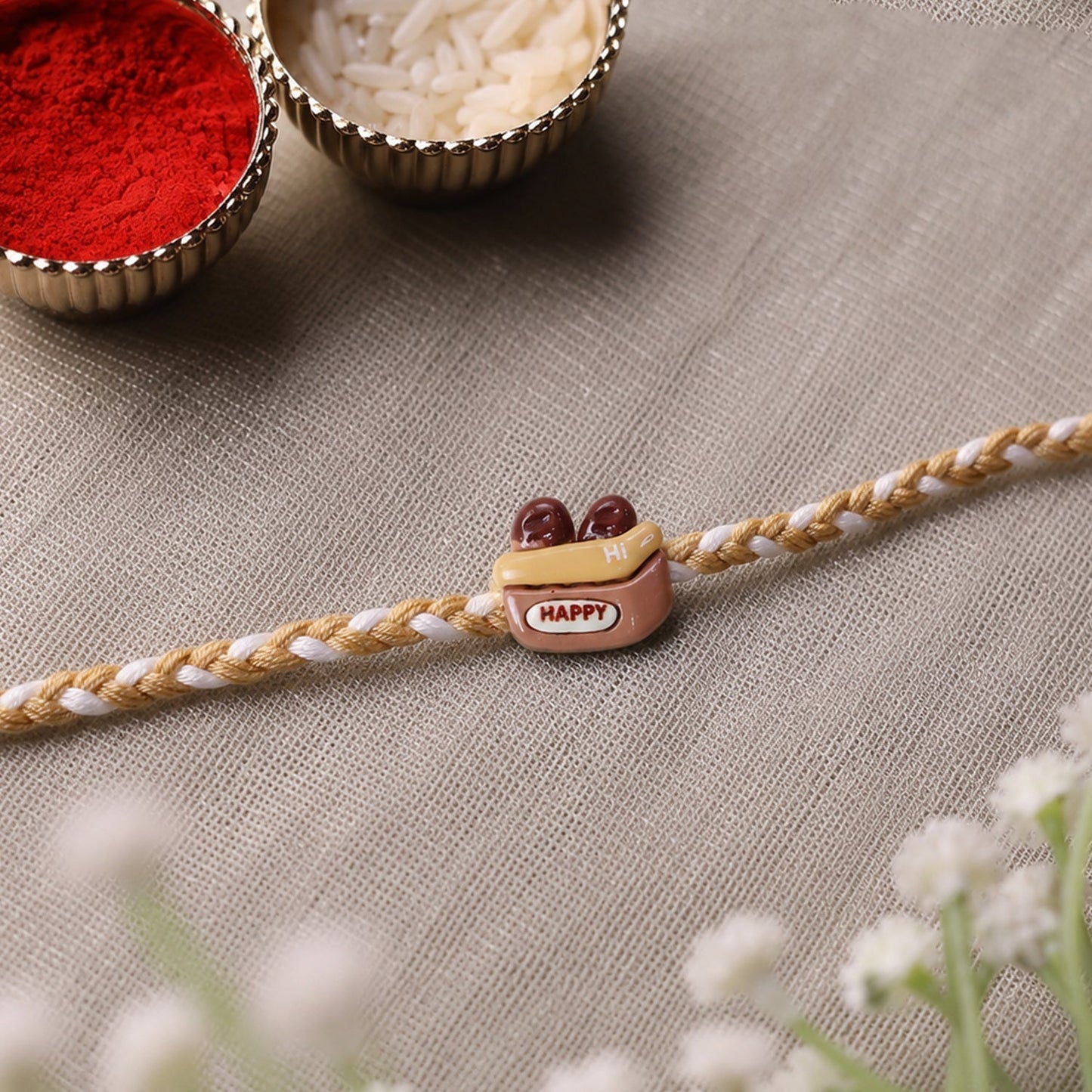 Vibrant thread and charm on modern Rakhi for brother