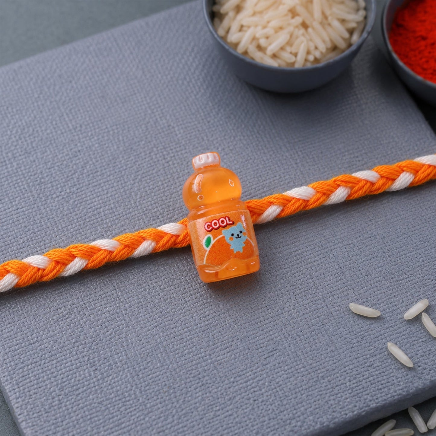 Side view of elegant finish of fancy drink bottle charm rakhi