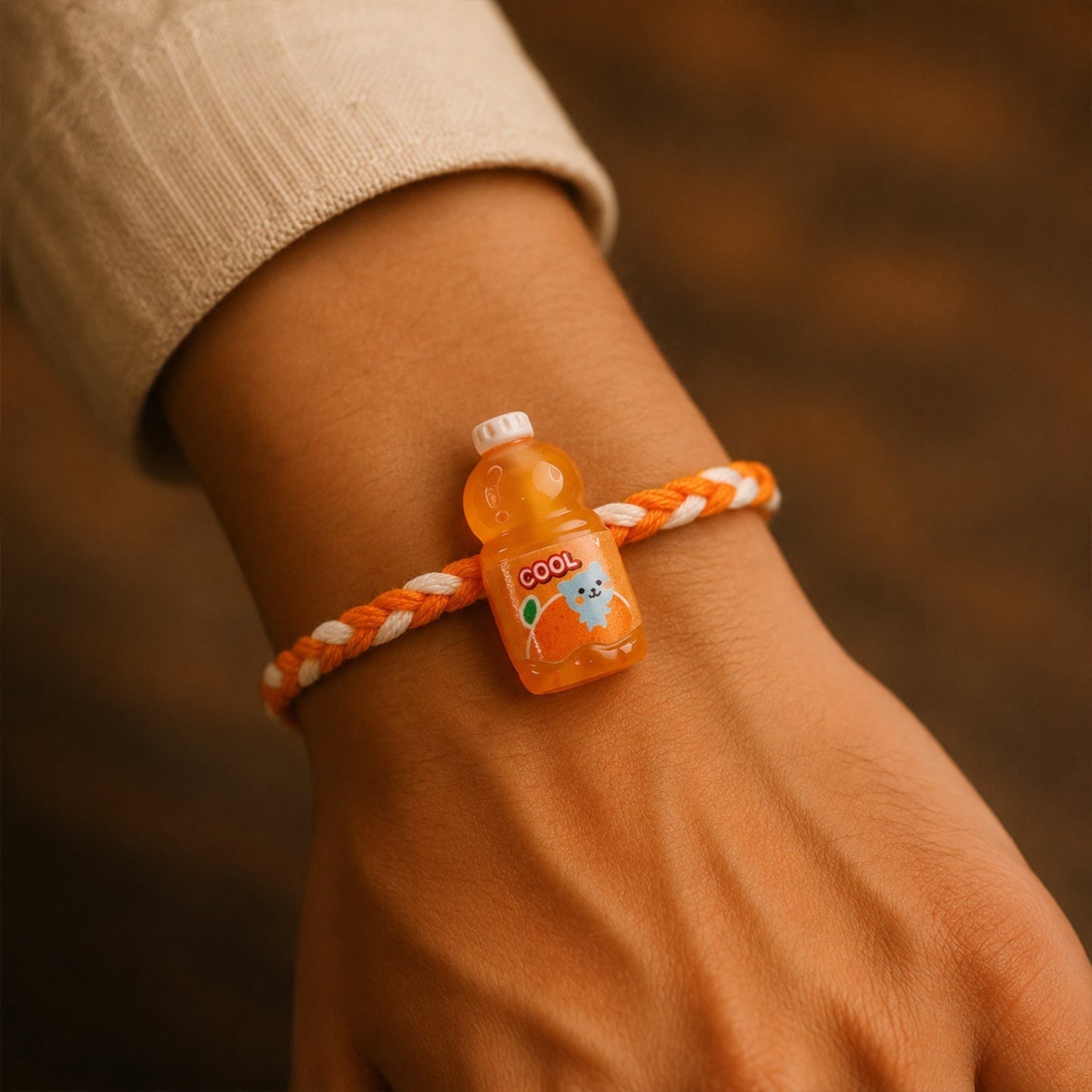 Top view of colorful threads on fancy drink bottle charm rakhi