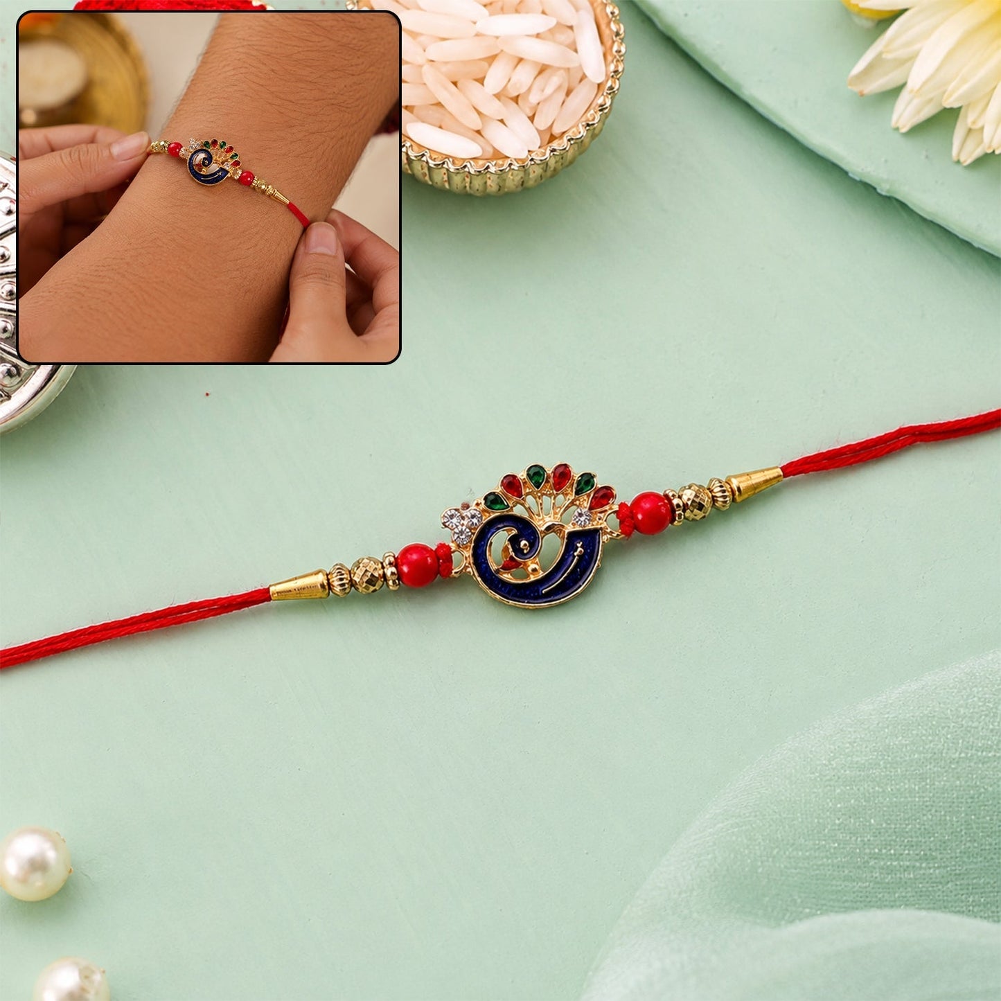 Vibrant peacock charm Rakhi with red beads and thread detail