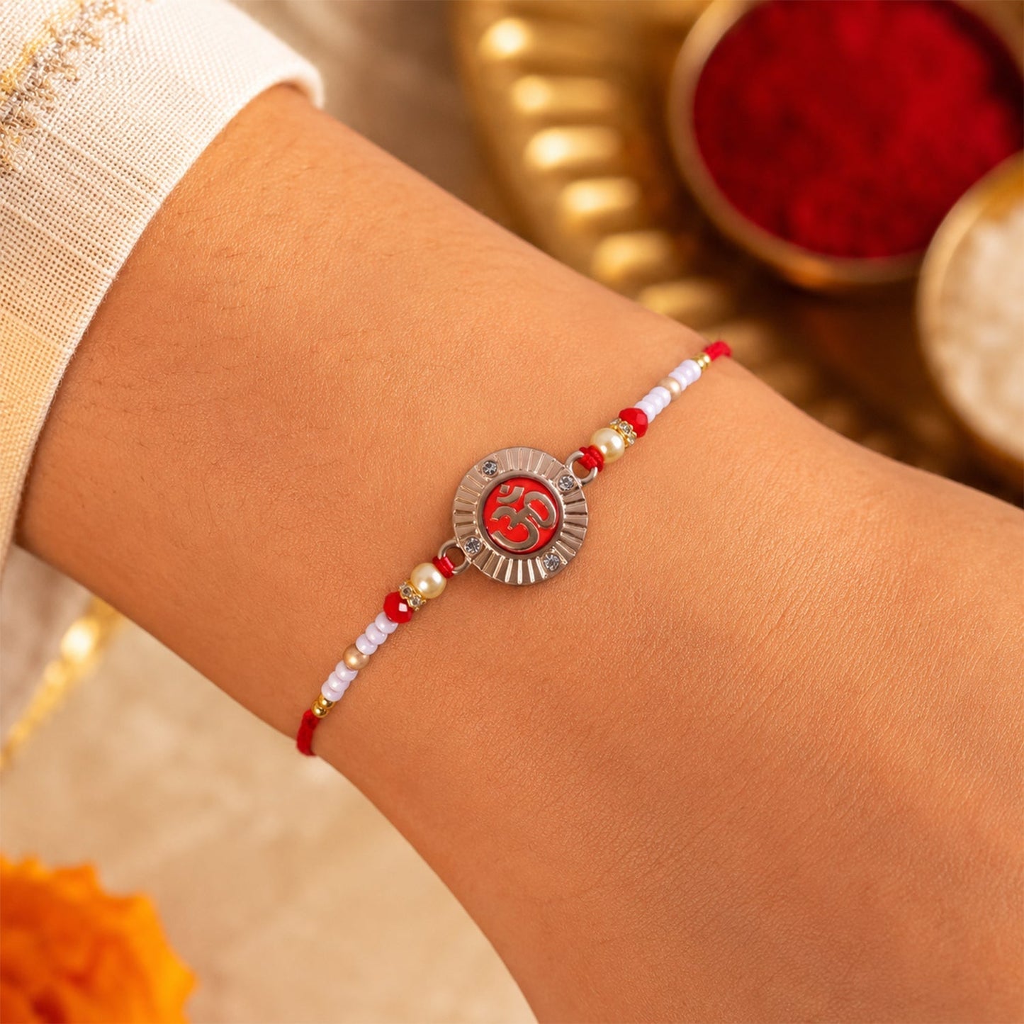 Side view of Om charm pearl bead rakhi
