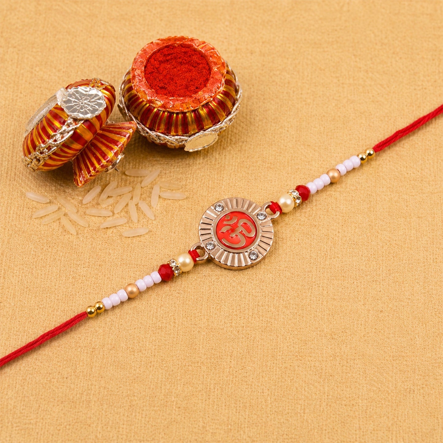 Full view of Om Round Charm Pearl Beads Rakhi on white background