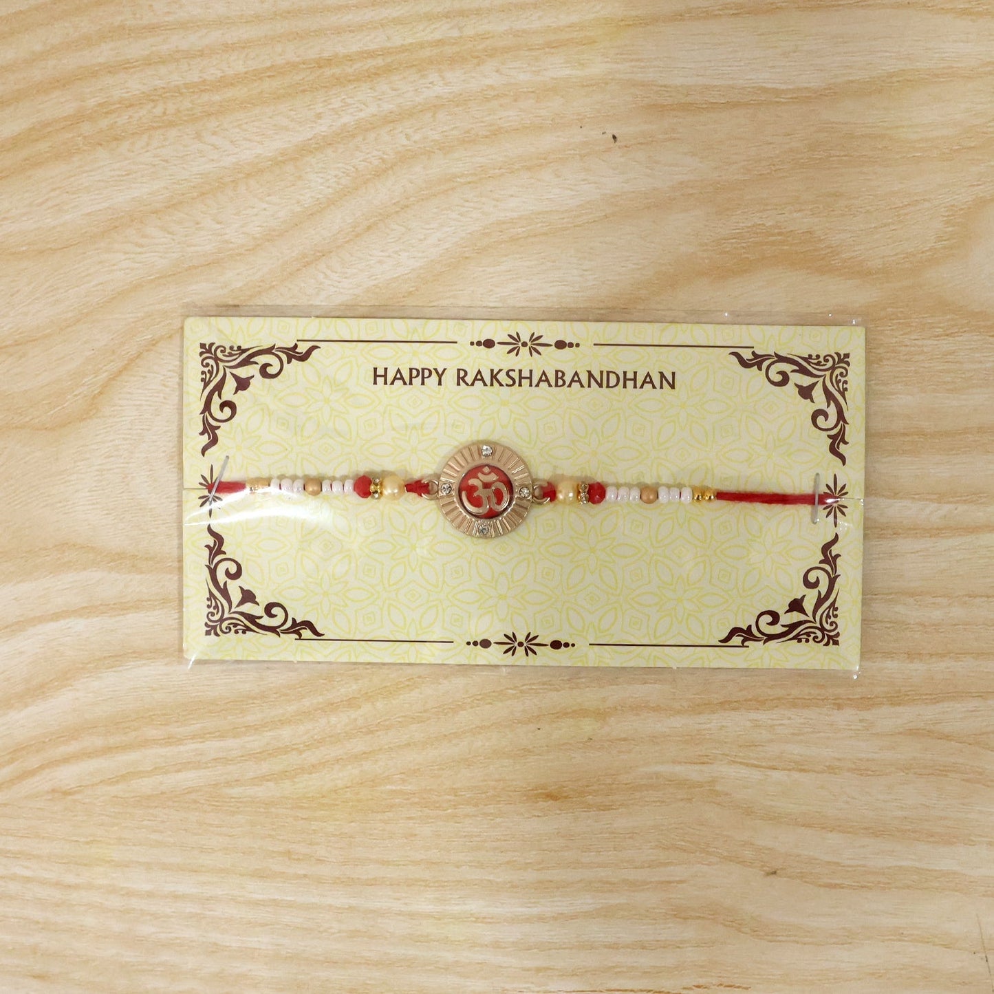 Pearl beads detail on Om charm rakhi