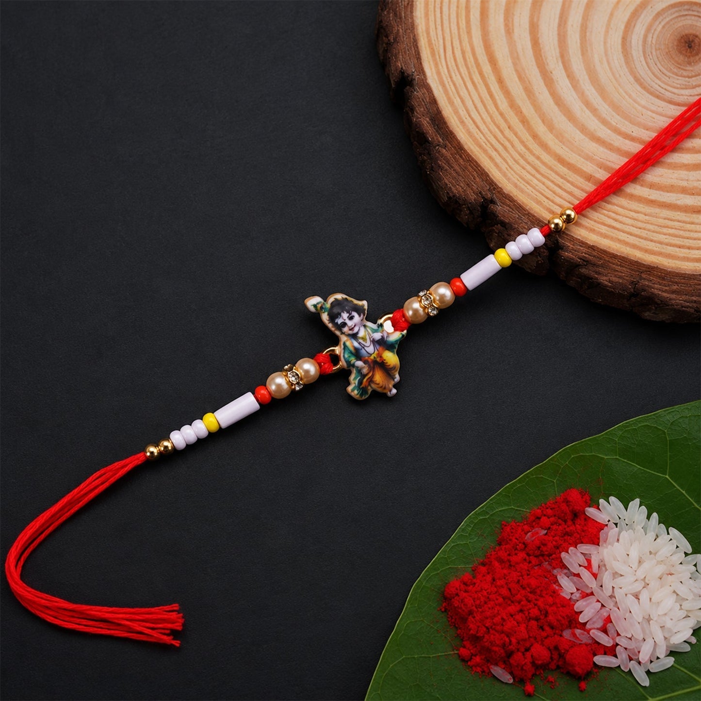 Close-up of Krishna Idol Charm on decorative Beads Rakhi