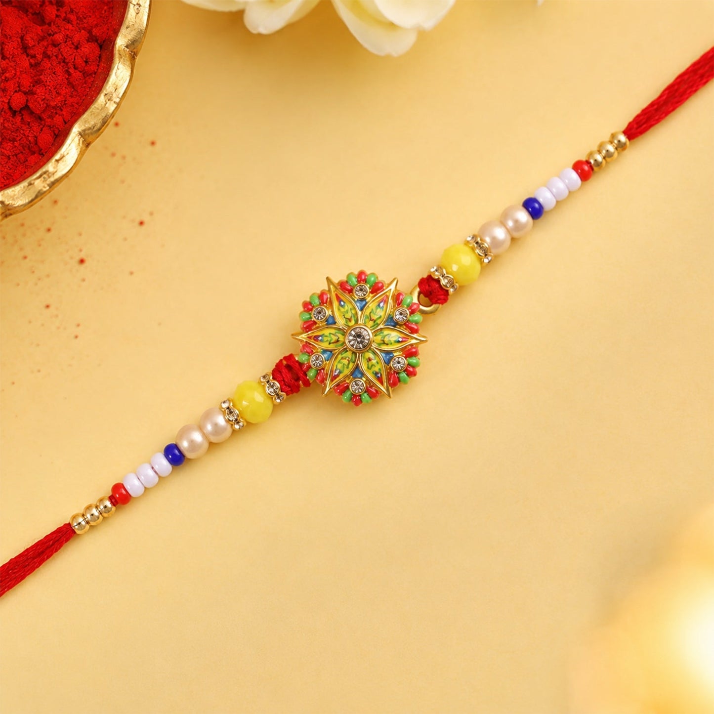 Close-up of Rakhi detail with beads and charm