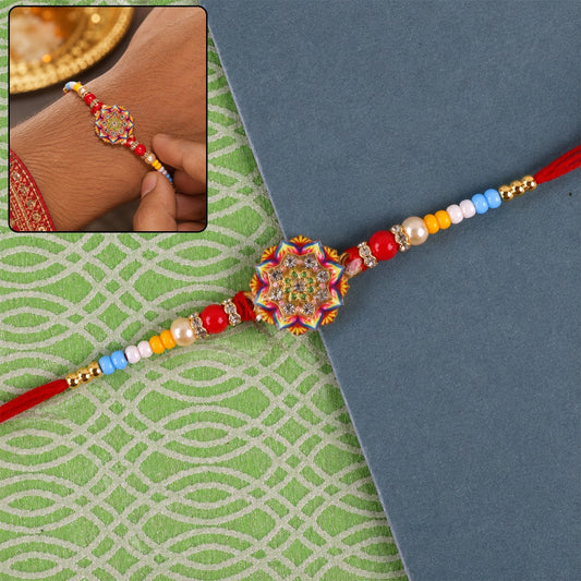 Front view of Rangoli Mandala stone charm Rakhi with pearl beads