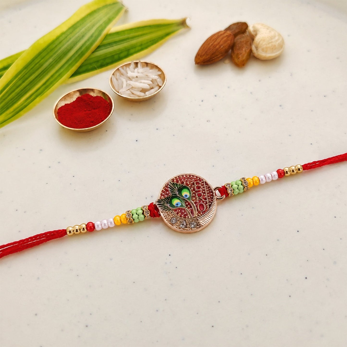 Side view of designer peacock feather rakhi with beads