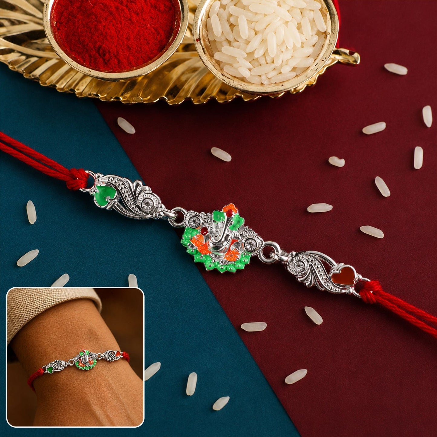 Silver Ganesh charm on red dori rakhi, front view, traditional festive accessory
