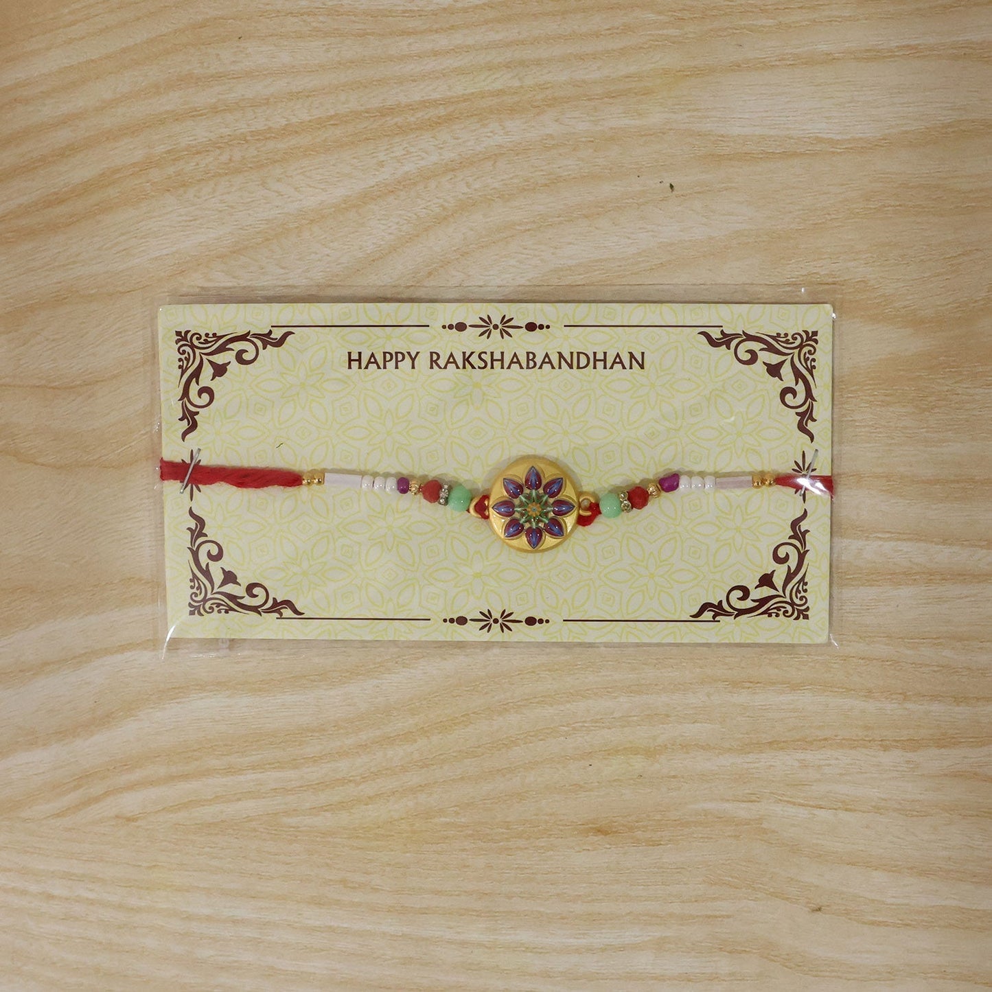 Close-up of ornamental charm on golden rakhi