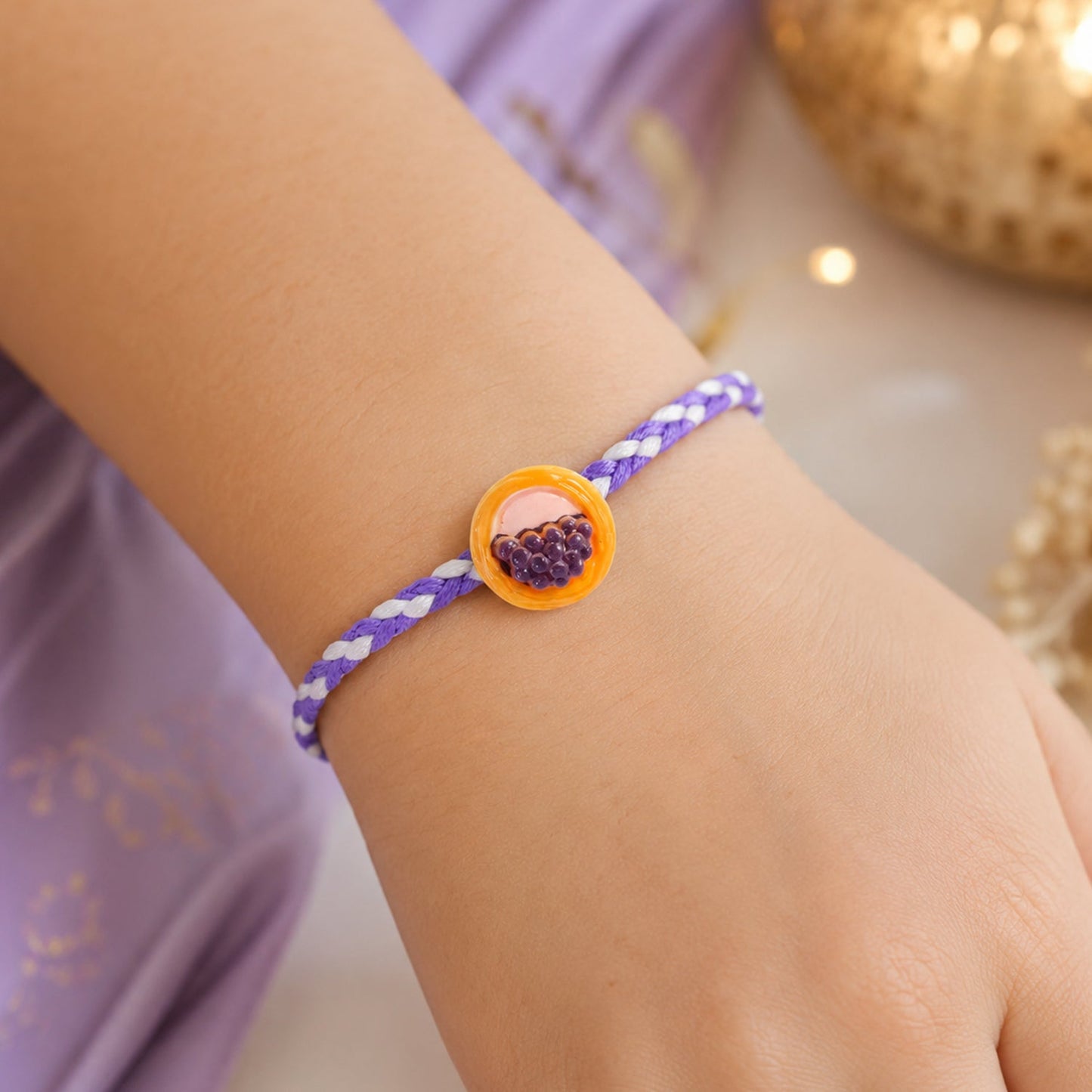 Side view of a stylish braided thread Rakhi with colorful design