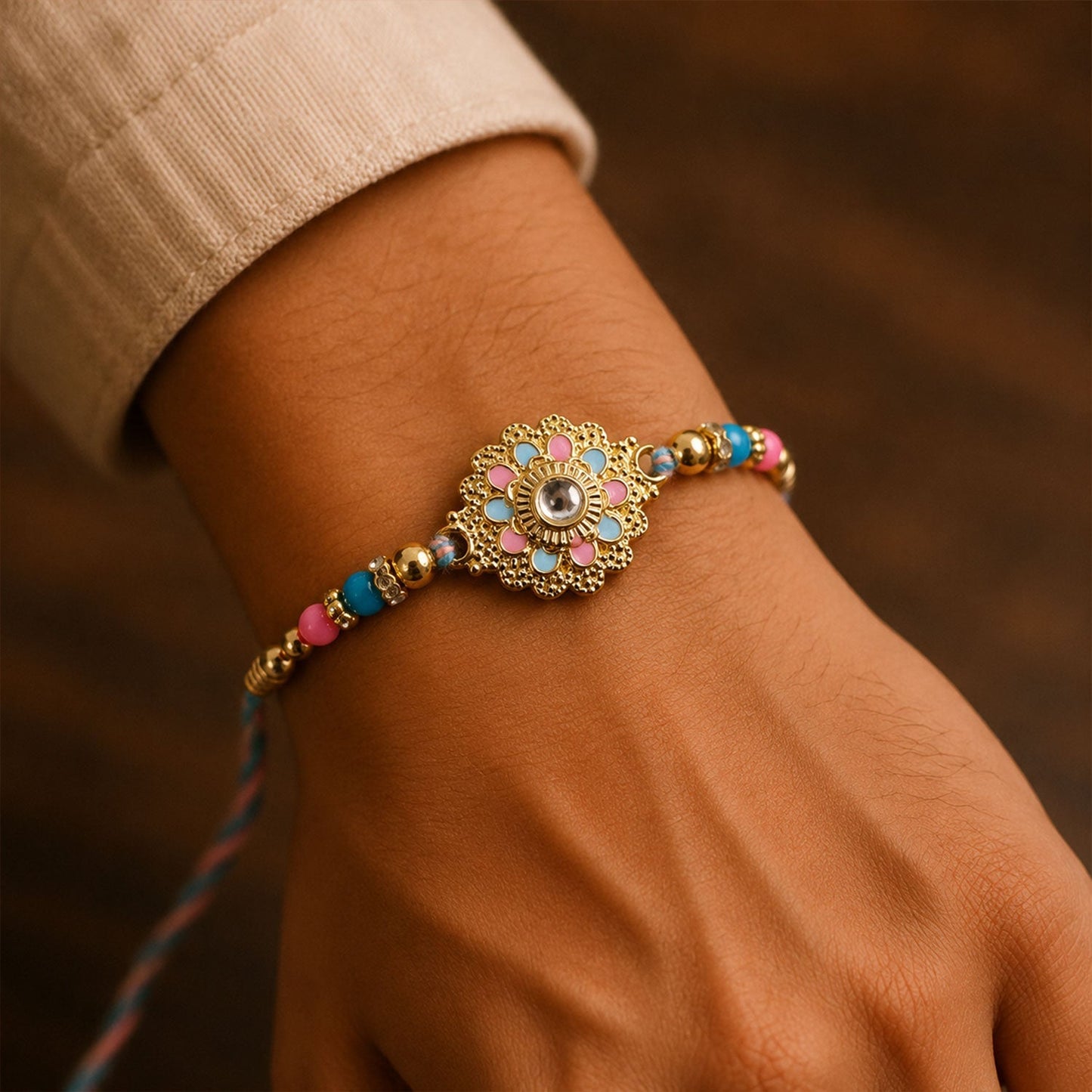 Side angle showing beads and charm details on rakhi