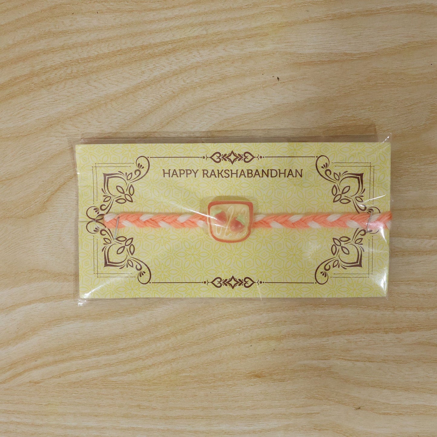 Braided thread Rakhi with a cute strawberry toast charm.