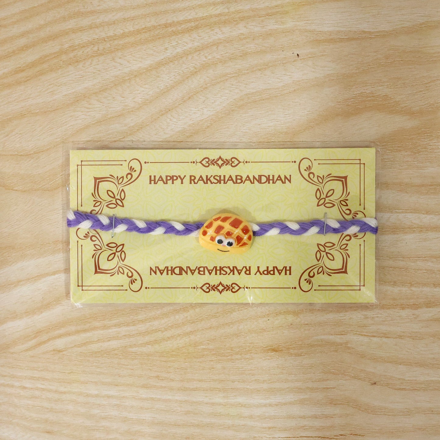 Angle view of Smiley Waffle Charm Braided Thread Rakhi