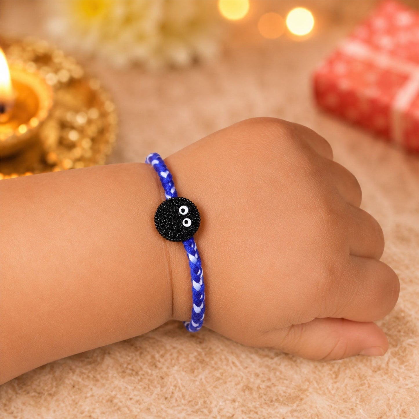 Side view of braided thread Rakhi with stylish cookie eyes charm