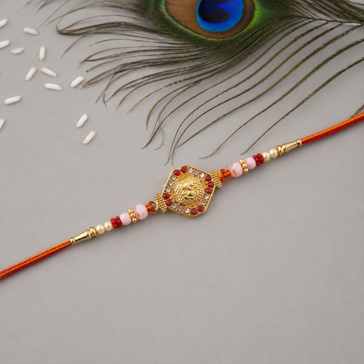 Side view of Ganesh hexagon stone charm rakhi with pearls, festive wear