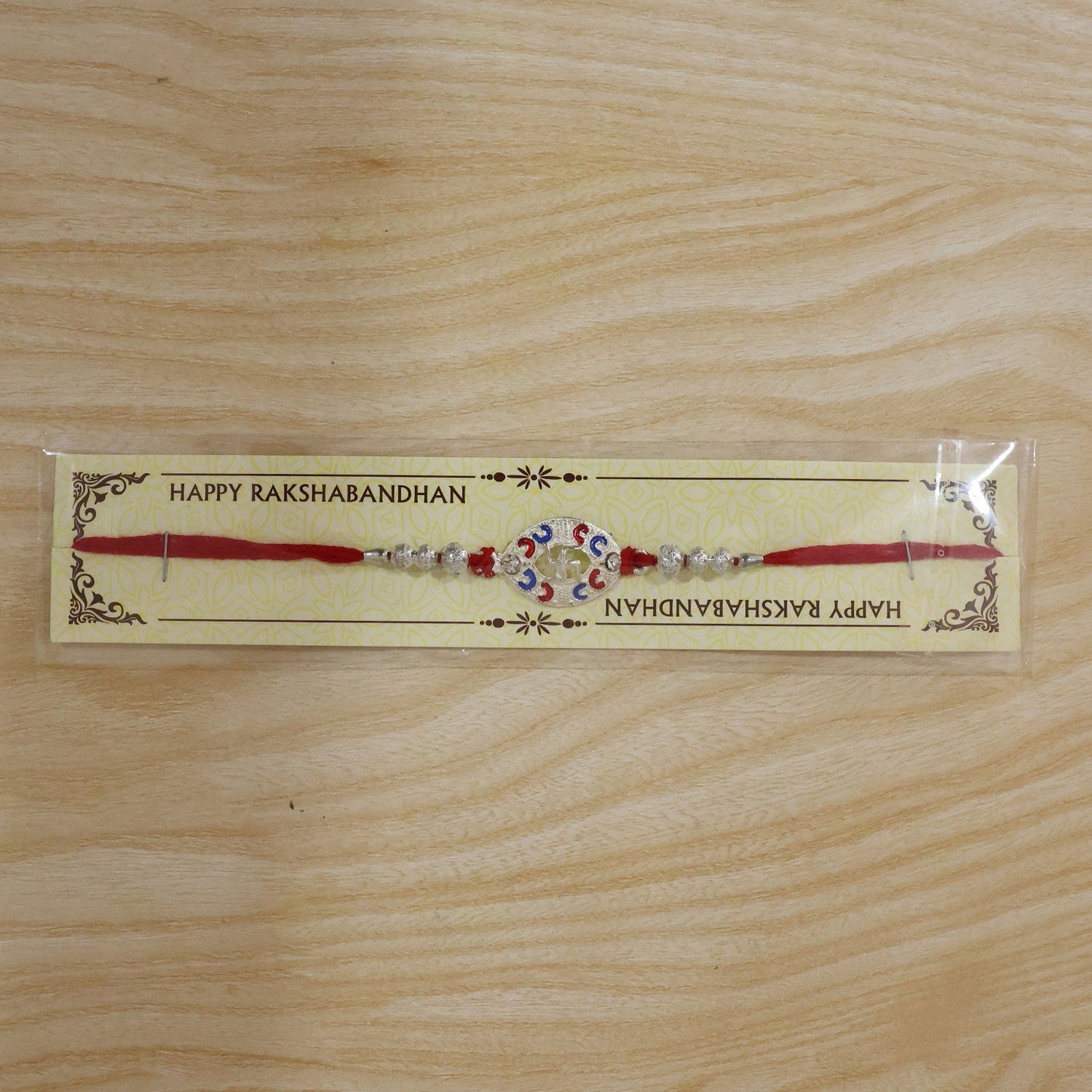 Packaging of Silver Swastik Meena Charm Rakhi for gifting