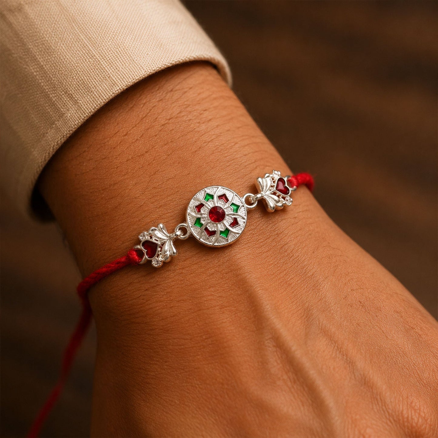 Side view of Silver Chakra Meena Heart Charm on Rakhi thread