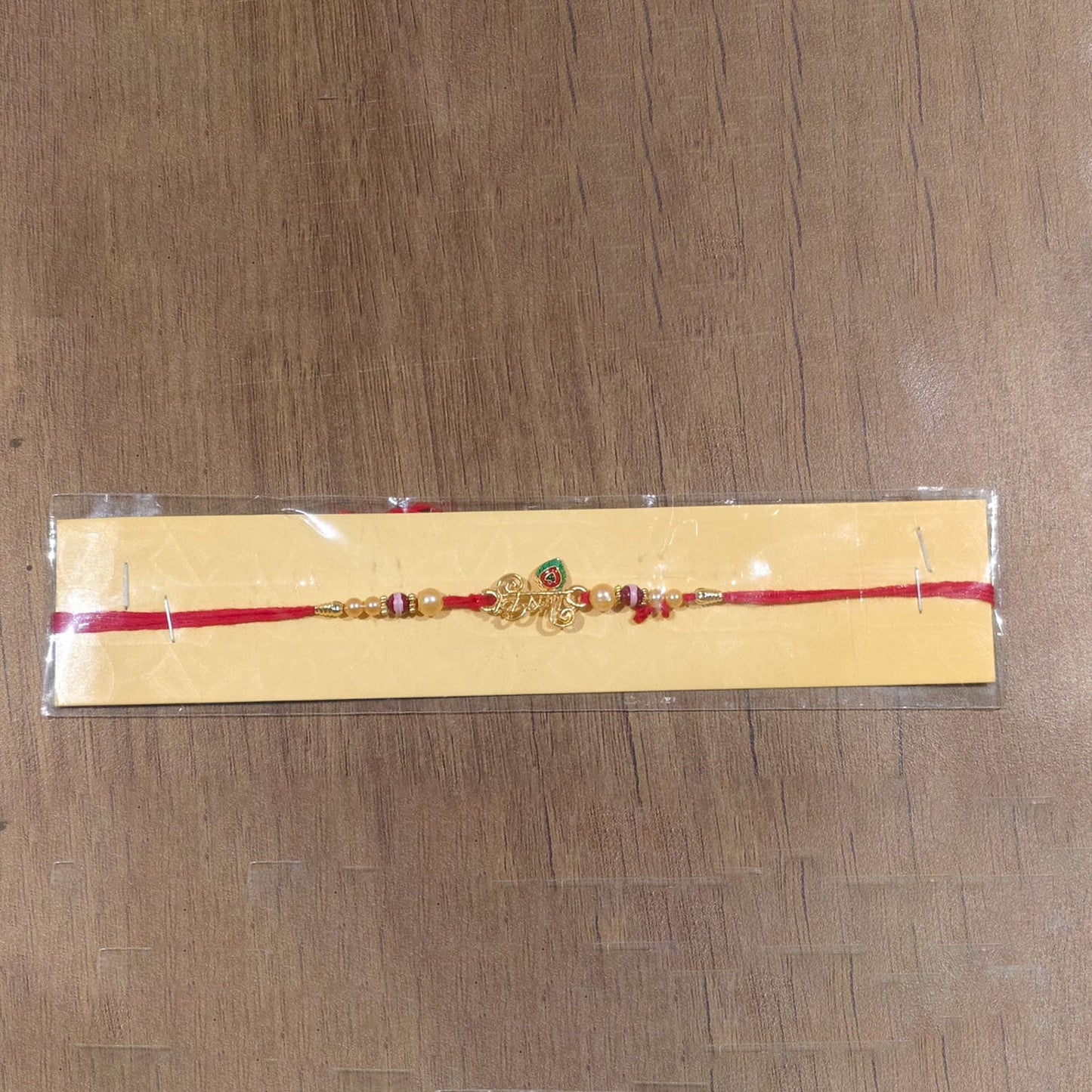 Full view of Krishna Mor Pankh Pearl Beads Rakhi with tying thread