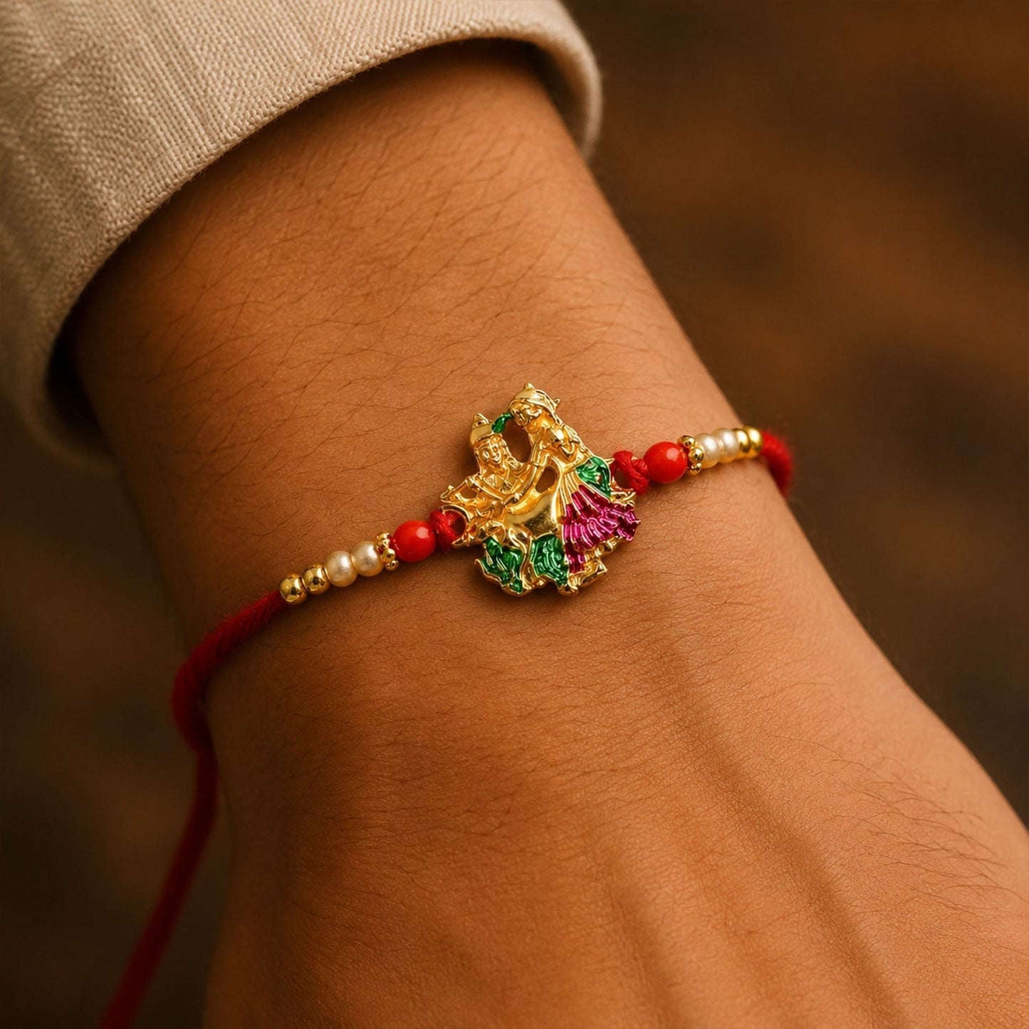 Side angle of Radha Krishna Meena rakhi showing intricate charm and beads