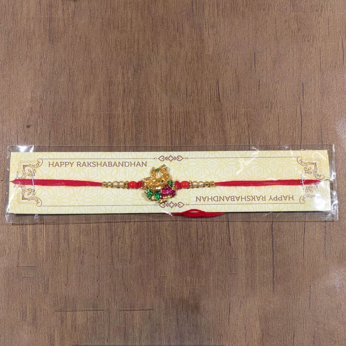 Intricate Radha Krishna Meena Beads rakhi with detailed charm design