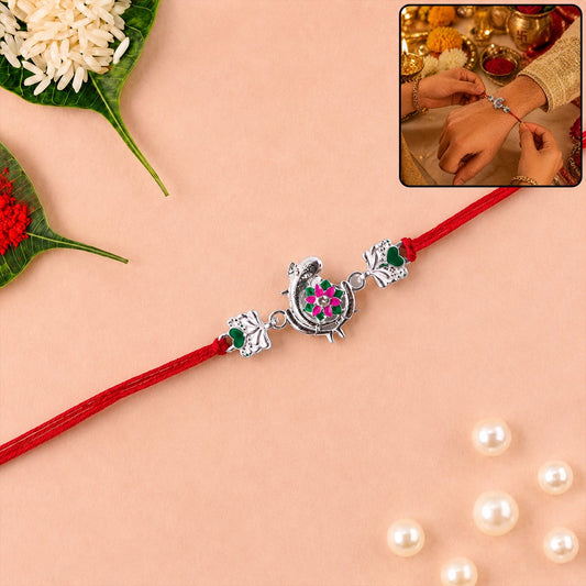 Silver Peacock Flower Heart Rakhi with dori showing intricate design