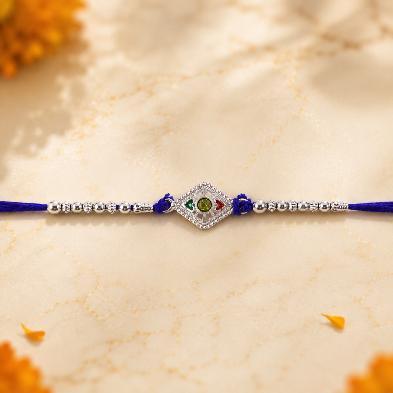 Close-up detail of the sparkling stone charm on the Silver Kite Rakhi.