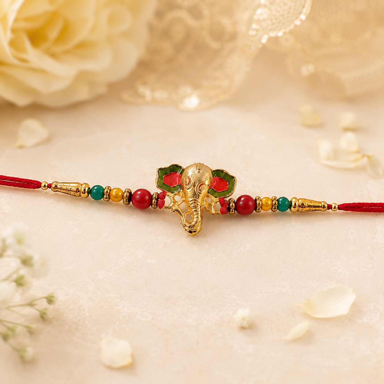 Golden Ganesha charm and thread on rakhi with intricate design